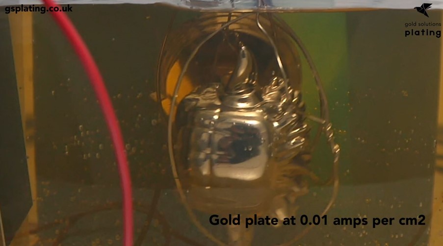 Plastic Star Wars toy inside a gold plating tank during electroforming